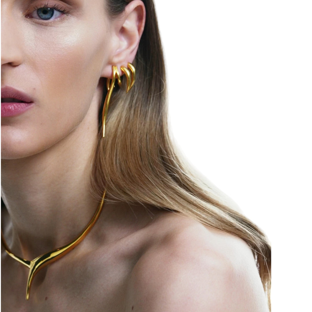 "Rhene Gold Earrings - Dynamic and Edgy Design" 2. "Eternal Waves Collection - Greek-inspired Gold Earrings" 3. "Versatile Rhene Earrings - Day to Night Glamour" 4. "Rhene Earrings - Timeless Beauty in 14K Gold" 5. "Greek Mythology Inspired Rhene Earrings - Chic and Sophisticated" 6. "Rhene Gold Earrings - Crafted with Eternal Elegance"